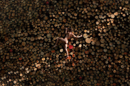 EDITIONS #3 | Human Nature: Sari holding onto tree logs